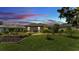 A spacious backyard, enhanced by a garden and pergola, offering a tranquil outdoor retreat at 364 Lake Vista Dr, Auburndale, FL 33823