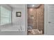 Modern bathroom with a soaking tub and a glass-enclosed shower featuring wood-look tiling at 364 Lake Vista Dr, Auburndale, FL 33823