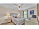 Cozy bedroom with neutral tones, a ceiling fan, and matching nightstands with lamps at 364 Lake Vista Dr, Auburndale, FL 33823