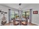 Cozy dining area features a glass top round table, seating for four, large windows, and elegant decor at 364 Lake Vista Dr, Auburndale, FL 33823
