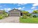 Charming one-story home with a well-manicured lawn and a two-car garage and paver driveway at 364 Lake Vista Dr, Auburndale, FL 33823