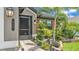 Charming home exterior with lush landscaping, brick walkway, and a screened front door at 364 Lake Vista Dr, Auburndale, FL 33823