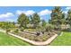 Backyard garden with raised beds, lush greenery, and blue sky views at 364 Lake Vista Dr, Auburndale, FL 33823