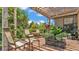 Inviting outdoor patio featuring comfortable seating, a pergola, brick pavers, and lush plants at 364 Lake Vista Dr, Auburndale, FL 33823