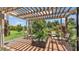 Backyard pergola area with patio furniture and landscaped garden at 364 Lake Vista Dr, Auburndale, FL 33823