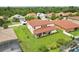 Aerial shot of a home featuring a red tile roof, spacious backyard, and a covered patio, nestled in a lush neighborhood at 3833 Bowfin Trl, Kissimmee, FL 34746