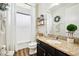 Bright bathroom with granite countertops, wooden accents, decorative plant, and shower with curtains at 3833 Bowfin Trl, Kissimmee, FL 34746