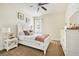 Cozy bedroom with a comfortable white bed, modern ceiling fan, and coordinated white furnishings at 3833 Bowfin Trl, Kissimmee, FL 34746