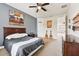 Bedroom with guitar decor, ceiling fan, and neutral colored carpet at 3833 Bowfin Trl, Kissimmee, FL 34746