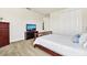 Bright bedroom featuring a bed, dresser, TV, carpet flooring, and a closet with white bi-fold doors at 3833 Bowfin Trl, Kissimmee, FL 34746