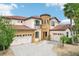 Stunning two-story home boasting a circular tower, three-car garage, and a beautiful tiled roof at 3833 Bowfin Trl, Kissimmee, FL 34746