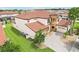 Aerial view of a two-story home with a circular tower, three-car garage, and beautiful landscaping at 3833 Bowfin Trl, Kissimmee, FL 34746