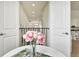 Hallway featuring an open view and a decorative floral arrangement on a white table at 3833 Bowfin Trl, Kissimmee, FL 34746