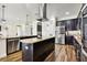 Contemporary kitchen with granite countertops, stainless steel appliances, and a kitchen island with bar seating at 3833 Bowfin Trl, Kissimmee, FL 34746