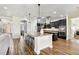 Modern kitchen with granite countertops, stainless steel appliances, and an island with bar stool seating at 3833 Bowfin Trl, Kissimmee, FL 34746