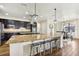 Spacious open kitchen with granite countertops, stainless steel appliances, and seating for four at the island at 3833 Bowfin Trl, Kissimmee, FL 34746