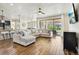 Bright open living area features wood-look tile flooring, ceiling fan and sliding glass doors to covered patio at 3833 Bowfin Trl, Kissimmee, FL 34746