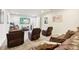 A spacious living room with comfortable brown leather seating, home theater system, and plush carpeting at 3833 Bowfin Trl, Kissimmee, FL 34746