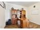 Office featuring custom wood built-ins, desk, and stylish wood-look tile flooring for a professional aesthetic at 3833 Bowfin Trl, Kissimmee, FL 34746