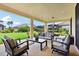 Relaxing covered patio area with stylish outdoor furniture and views of the lush green backyard at 3833 Bowfin Trl, Kissimmee, FL 34746
