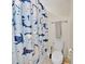A clean, well-maintained bathroom with a shark-themed shower curtain and matching decor at 3853 Cortland Dr, Davenport, FL 33837