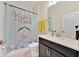 Cute bathroom with cheerful shower curtain, white countertop and vanity at 3853 Cortland Dr, Davenport, FL 33837