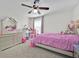 Comfortable bedroom featuring carpet flooring, a ceiling fan, and a large window at 3853 Cortland Dr, Davenport, FL 33837