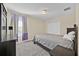 Neutral bedroom with a cozy gray bed, soft carpet, and ample natural light through large window at 3853 Cortland Dr, Davenport, FL 33837