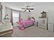 Bright bedroom with a ceiling fan, window, and furnished with furniture at 3853 Cortland Dr, Davenport, FL 33837