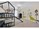 A bedroom featuring a unique bunk bed, dinosaur-themed decor and natural lighting at 3853 Cortland Dr, Davenport, FL 33837