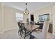 Dining room with a modern chandelier, large window, and view of a fish tank on a sideboard at 3853 Cortland Dr, Davenport, FL 33837
