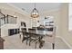 Dining room with stairs and adjacent living areas featuring a modern chandelier and tan tile floors at 3853 Cortland Dr, Davenport, FL 33837