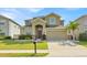 Charming two-story home with a well-manicured lawn and a two-car garage in a Gathering-friendly neighborhood at 3853 Cortland Dr, Davenport, FL 33837