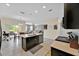 Open kitchen featuring dark wood cabinets, a central island and views into the living area at 3853 Cortland Dr, Davenport, FL 33837