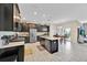 Spacious kitchen with sleek black cabinetry, stainless steel appliances, and an island at 3853 Cortland Dr, Davenport, FL 33837
