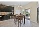 Eat-in kitchen featuring dark cabinets and countertops, stainless appliances and a dining area at 3853 Cortland Dr, Davenport, FL 33837