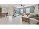 Inviting living room with tile flooring, a ceiling fan, and a comfortable sectional sofa at 3853 Cortland Dr, Davenport, FL 33837