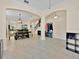 Bright and spacious living room with tile flooring, archways, and an adjacent dining area with modern light fixture at 3853 Cortland Dr, Davenport, FL 33837