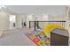 Cozy upstairs loft space with a colorful rug and a comfortable seating area at 3853 Cortland Dr, Davenport, FL 33837
