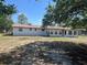 The back exterior features a spacious yard and numerous windows for ample natural light at 3949 Millstone St, Lake Wales, FL 33898
