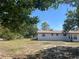 Spacious backyard featuring a well-maintained lawn and a charming white house under a clear blue sky at 3949 Millstone St, Lake Wales, FL 33898