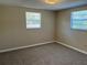Bedroom with beige carpeting and natural lighting from two windows at 3949 Millstone St, Lake Wales, FL 33898