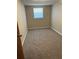 Bedroom with tan carpet and a single window at 3949 Millstone St, Lake Wales, FL 33898
