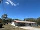 Charming one-story home featuring a large carport and attached storage shed at 3949 Millstone St, Lake Wales, FL 33898