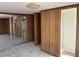 Hallway with a sliding glass door, wood paneled walls, and linoleum flooring at 3949 Millstone St, Lake Wales, FL 33898