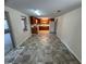 A galley kitchen with tile flooring adjacent to an enclosed porch at 3949 Millstone St, Lake Wales, FL 33898