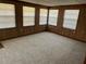Spacious sunroom featuring wood paneled walls and carpeting at 3949 Millstone St, Lake Wales, FL 33898