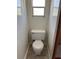 Standard toilet with white porcelain, a white tank, and tile flooring at 3949 Millstone St, Lake Wales, FL 33898