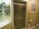 Bathroom featuring a glass shower with a sliding door and a marble countertop vanity at 4007 Cypress Lndg S, Winter Haven, FL 33884