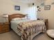 Inviting bedroom with a wooden bed frame, soft carpet, and decorative fish on the wall at 4007 Cypress Lndg S, Winter Haven, FL 33884